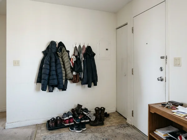 Before: bare condo entry wall with shoes on the floor in CityPlace