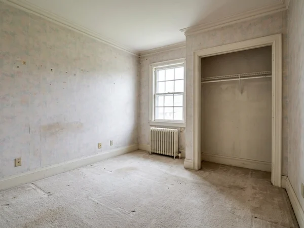 Before: empty former nursery with a wire closet rod in Lawrence Park