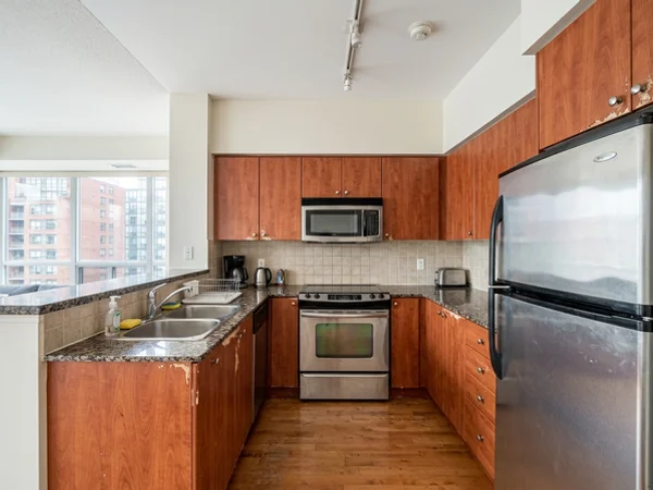 Before: original laminate condo kitchen in a Yorkville tower