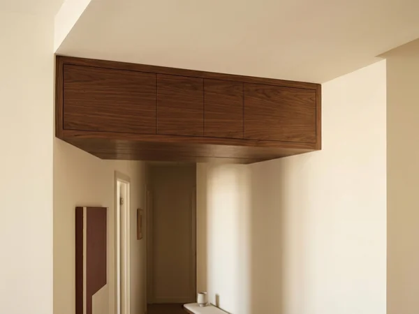 Cabinets built into a bulkhead void above a hallway